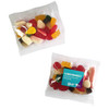 A clear bag of mixed lollies featuring various shapes and vibrant colours, including reds, yellows, and whites.