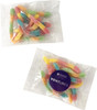 A packet of colourful gummy sour worms in pink, yellow, blue, and green, with a logo on the packaging.