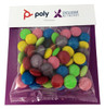A clear bag filled with brightly coloured choc beans, including green, pink, yellow, and purple, on a branded backing.