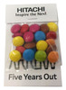 A bag of multi-coloured chocolate beans, featuring pink, blue, yellow, orange, and brown candies, with branding on the packaging.