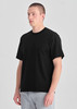 A black men's box tee displayed on a model, featuring a relaxed fit and short sleeves.