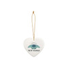 A ceramic ornament in a heart shape, featuring a blue insect design and a gold hanging string.
