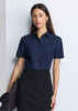 A navy women's short sleeve shirt with a collared neckline and buttons, paired with a black skirt.
