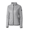 A light grey women's jacket with a quilted design, featuring a zip front and side pockets. It has a logo on the sleeve.