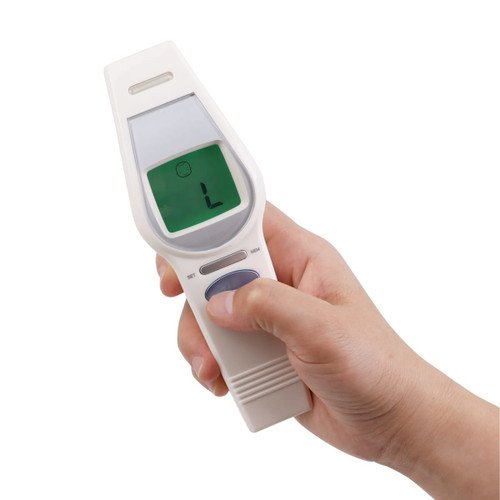 A white touchless digital infrared forehead thermometer held in a hand, featuring a digital display.