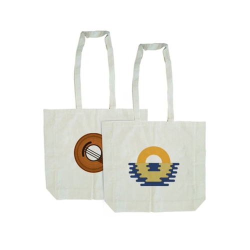A calico tote bag in natural colour with long handles, featuring two different graphic designs and a logo.