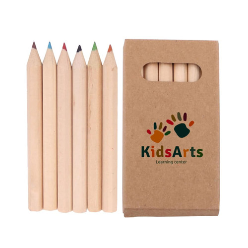 A set of six unsharpened coloured pencils in a cardboard box with a logo. The pencils include red, green, blue, and brown.