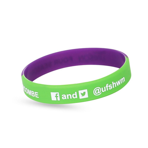 A green and purple silicon wristband featuring a logo and social media handles.
