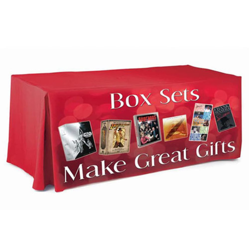 A red 8ft table cloth with pleated sides and a logo, featuring images of box sets and text.