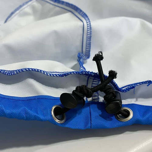 A blue and white spare tyre cover featuring toggle fasteners and eyelets. It has a durable fabric finish.