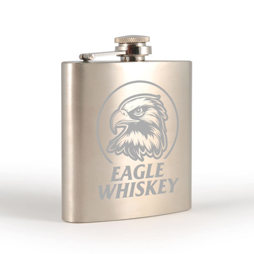 A stainless steel hip flask with an engraved eagle design, featuring a screw-top lid.