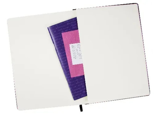 A large cream notebook with lined pages and an elastic closure, featuring a purple insert inside.