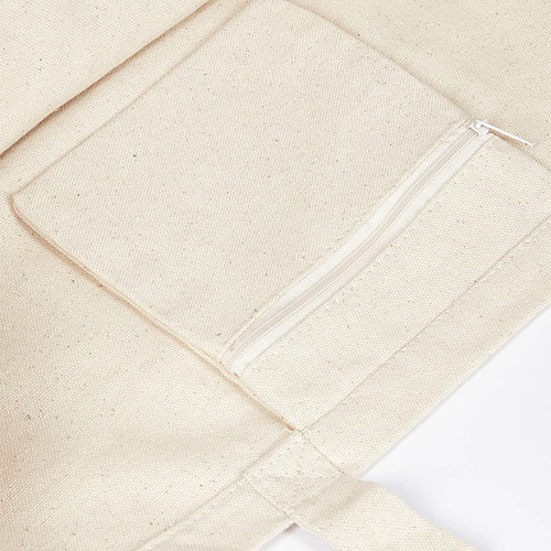 A cream-coloured canvas tote bag featuring a zippered pocket on the front. It has a simple, unembellished design.