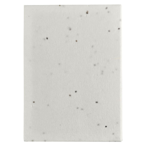 A sticky note pad with a speckled white design, featuring a plain cover and rectangular shape.