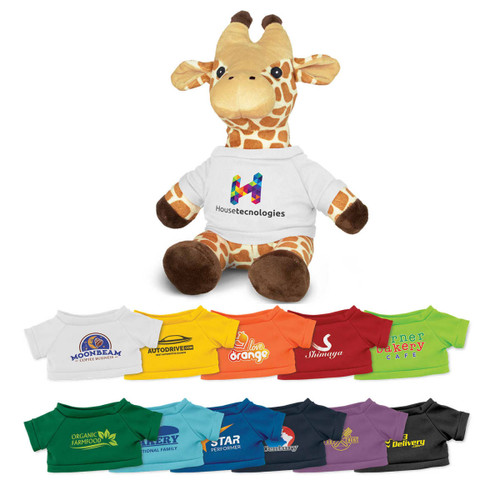 A plush giraffe toy in tan and brown, wearing a white shirt with a logo, surrounded by various coloured t-shirts.