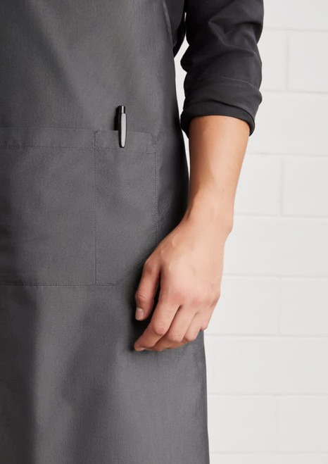 A grey Urban Bib Apron featuring a pocket and a pen holder, highlighting its practical design.