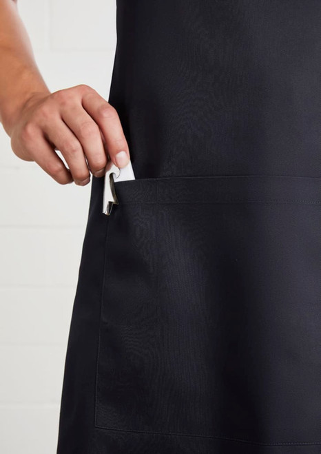 A black bib apron with a hand inserting a clip into a pocket, featuring a logo.