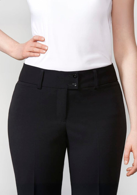 A pair of black women's slacks with a fitted waist and button fastening, worn with a white top.
