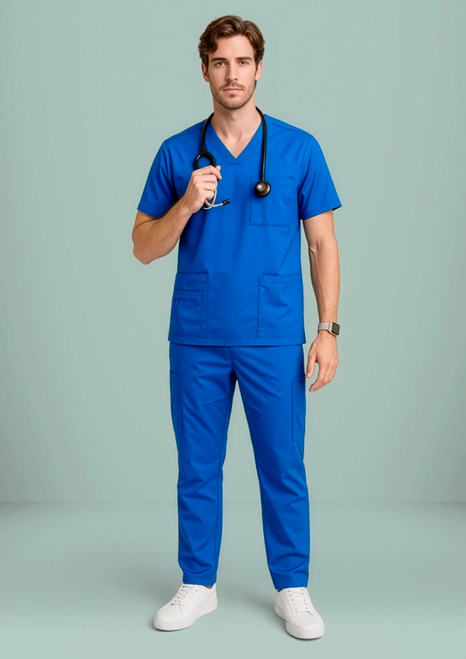 A man wearing a blue V-neck scrub top and matching trousers, holding a stethoscope, with a logo visible.