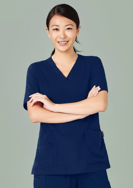 A women's navy V-neck scrub top with short sleeves and two front pockets, featuring a logo.