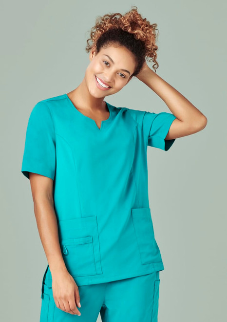 A women's scrub top in teal with a round neck, featuring short sleeves and front pockets.