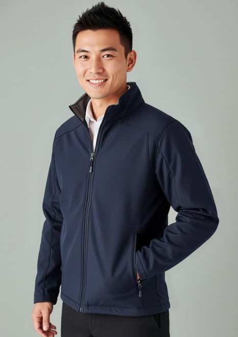 A navy soft shell jacket with a zip front, side pockets, and a collar, worn by a smiling male model.
