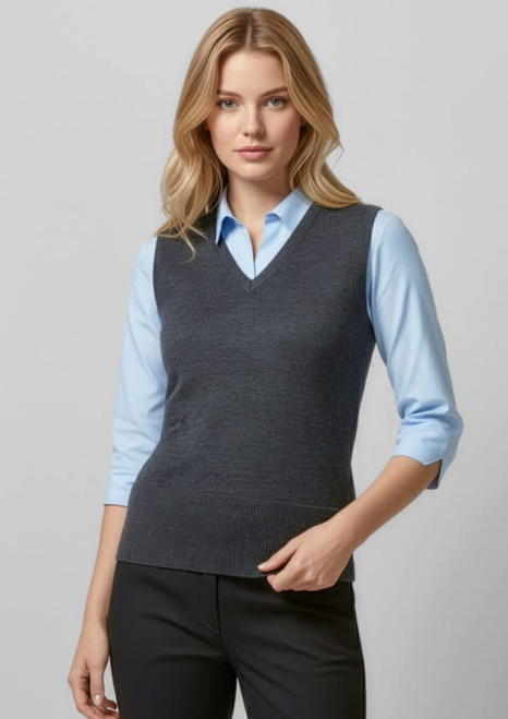 A grey women's vest with a v-neck design, worn over a light blue shirt and paired with black trousers.