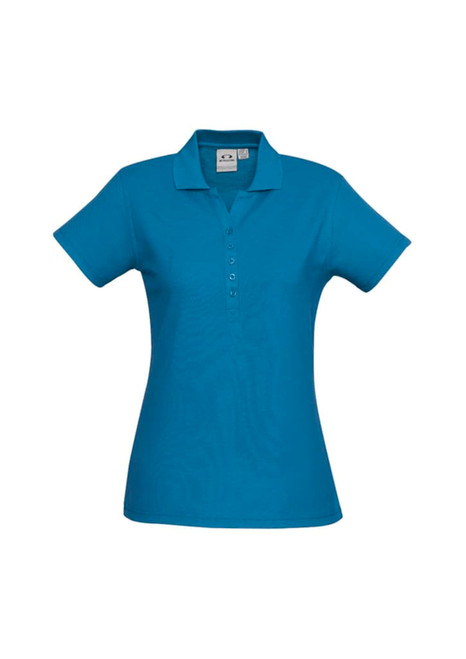 A blue ladies polo shirt featuring a collar and button placket, with a logo on the fabric.