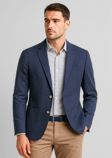 A navy blazer worn over a checked shirt, styled with beige trousers, featuring two buttons and a pocket.
