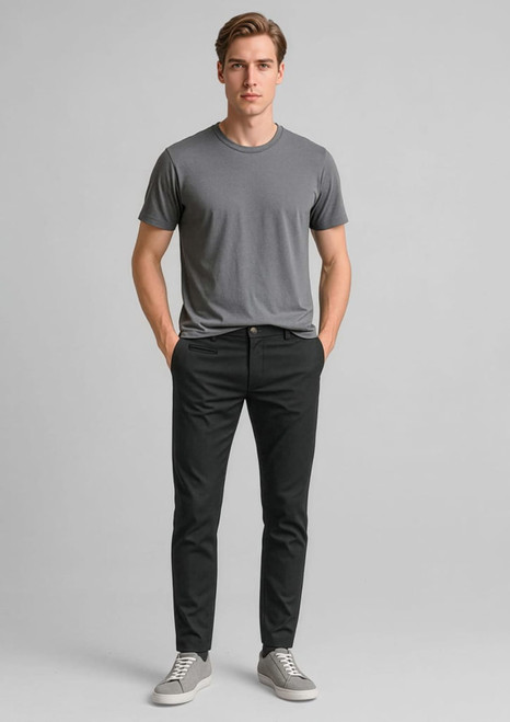 A model wearing black tapered stretch chino pants paired with a grey t-shirt and grey sneakers.