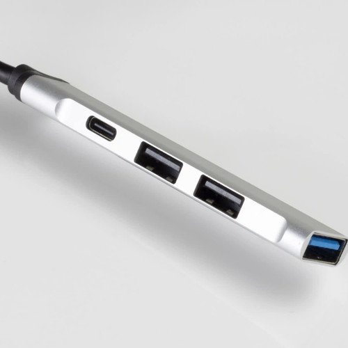 A silver USB hub with multiple ports, including USB-A and USB-C, on a white background.