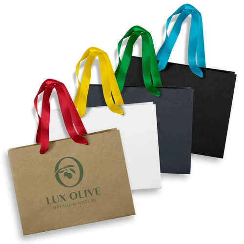 Four medium ribbon handle paper bags in brown, white, black, and kraft, each featuring a logo and colourful ribbons.