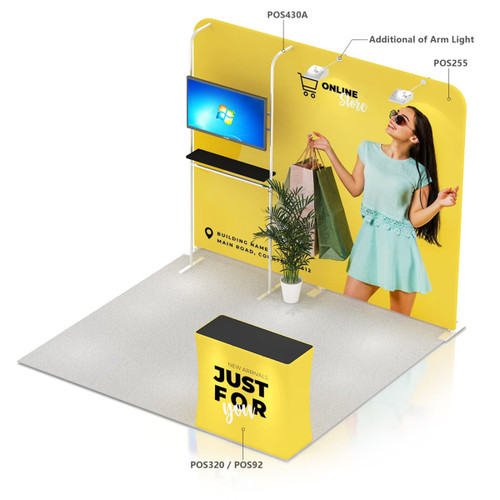 A promotional display featuring a yellow booth, monitor mount, shelves, and an arm light, with a vibrant background.