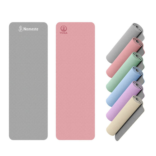 A grey and pink yoga mat, alongside a stack of pastel-coloured mats, featuring a logo on each mat.