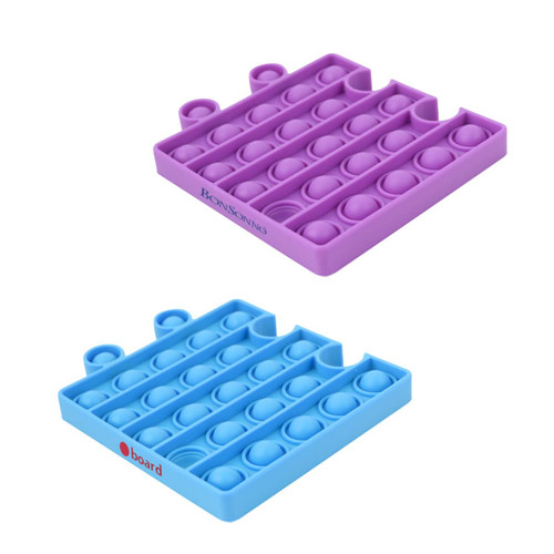 A purple and blue Puzzle Shape Pop It Fidget Toy, featuring multiple bubble shapes for popping. Includes branding.