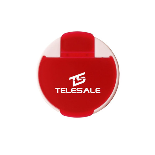 A round pill box in red and white with a branded logo on the front.