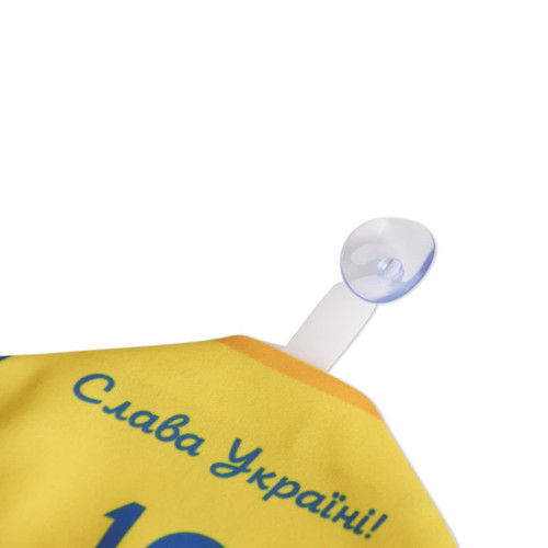 A yellow custom mini jersey with a clear suction cup for hanging, featuring a logo and text.