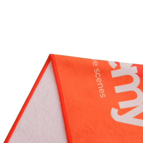 An orange sports towel, featuring a logo, with a soft texture and contrasting edges.