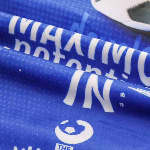 A vibrant blue sports towel with a smooth surface, featuring a logo and text against a textured background.