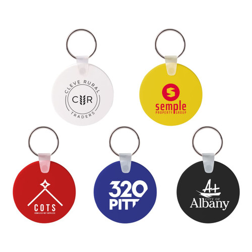 A collection of round Durasoft keyrings in white, red, blue, yellow, and black, each featuring a logo.