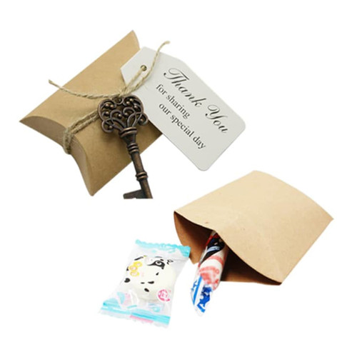 A small brown kraft pillow box with a key and a thank you tag, partially open revealing a candy inside.