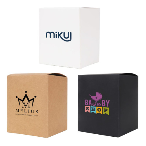 Three large square gift boxes in white, brown, and black with various logos and branding.