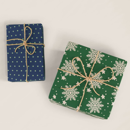Two wrapped gifts, one in blue with polka dots and the other in green with snowflakes, both tied with twine.