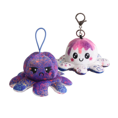 A small reversible octopus plush toy in vibrant blue and white, featuring a happy and an angry face, with a clip attachment.