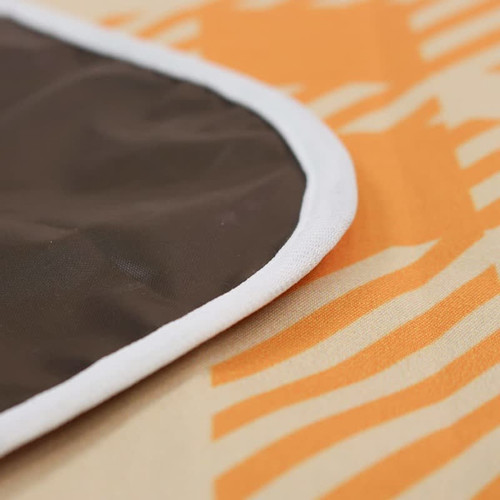 A picnic blanket with a patterned orange design and a brown trim. It features a logo on the edge.