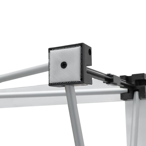 A close-up of a fabric popup display frame, featuring grey metal components and a textured connector.