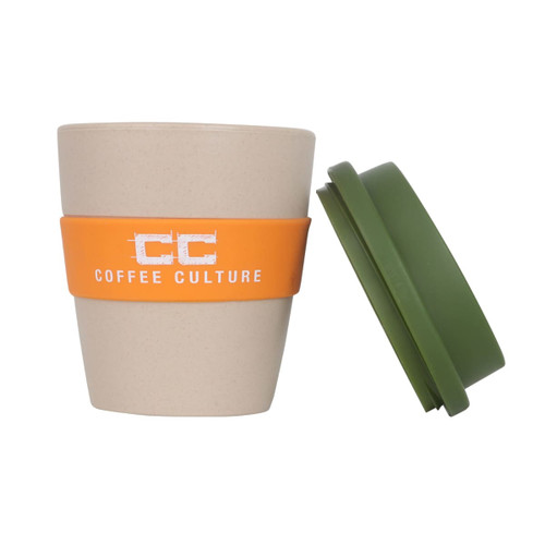 A reusable coffee cup made from natural rice husk fibre, featuring a cream body, orange band, and green lid.