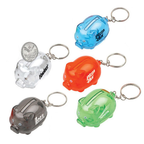 A set of mini piggy bank keyrings in clear, orange, green, and two opaque colours, featuring various logos.