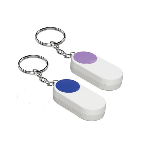 A pair of white pill boxes with coloured buttons, attached to keychain rings.