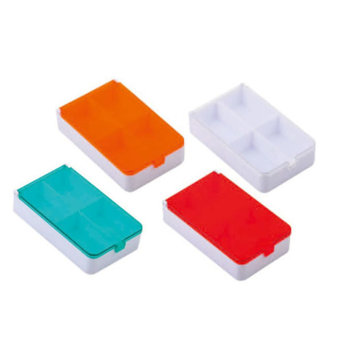 Four rectangular pill boxes in orange, teal, red, and white, with separate compartments for organisation.